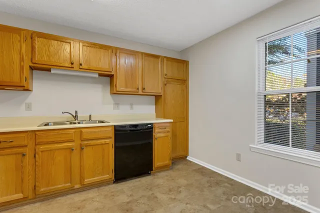 a kitchen with a stove a sink and a refrigerator