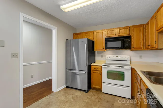 a kitchen with a refrigerator sink and stove top oven