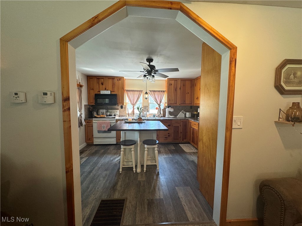 1480 Jerrys Run Road Belleville, WV 26133 - Photo 16 of 48 Living room featuring wooden walls, ceiling fan, and carpet floors