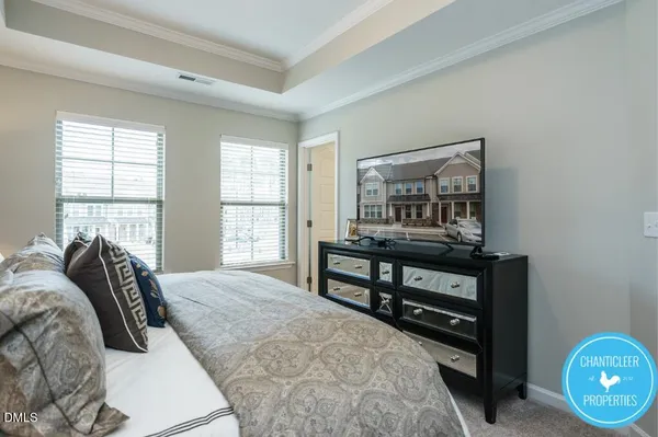 a bedroom with a bed and a night stand next to a window