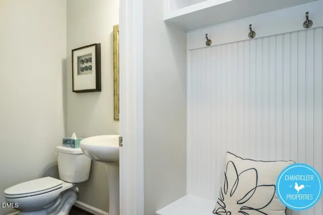 a white toilet sitting next to a shower curtain