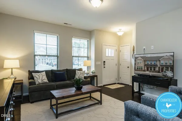 a living room with furniture and wooden floor