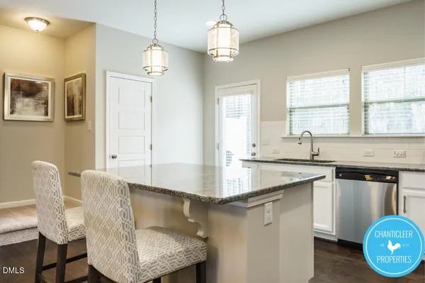 a kitchen with granite countertop a sink cabinets and window