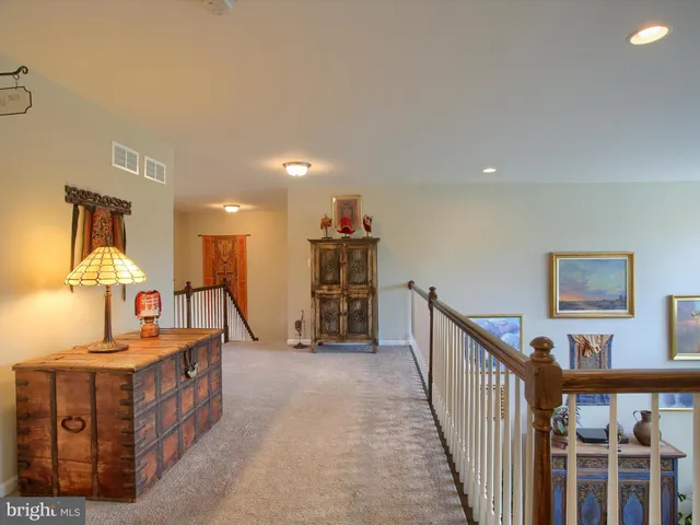 a view of a patio with table and chairs potted plants and a large tree
