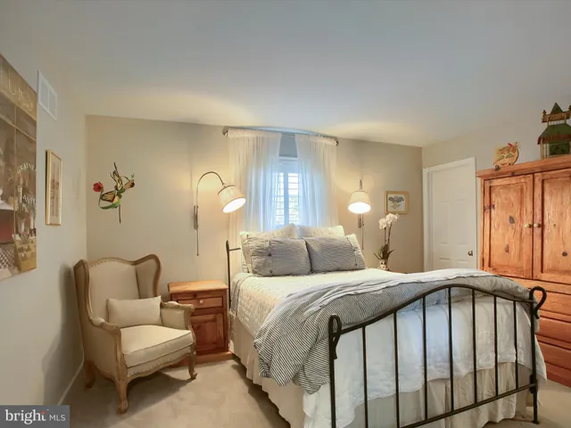 a view of a patio with a table and chairs and potted plants