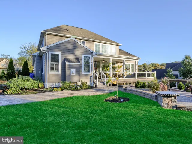 a view of a house with a yard and sitting area