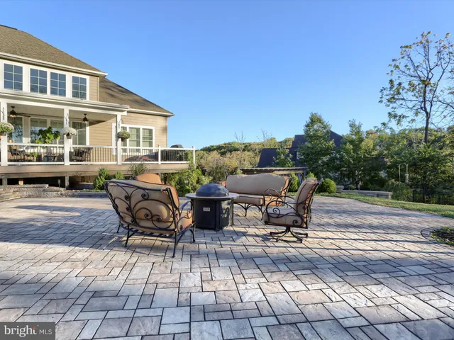a view of a swimming pool with an outdoor seating and a yard