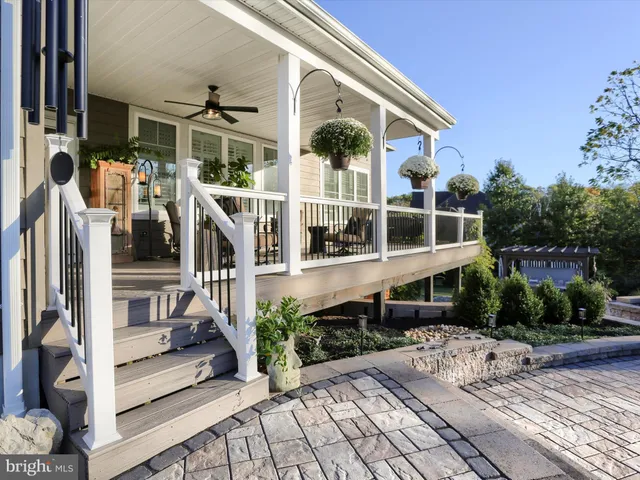 a view of a porch with furniture and potted plants