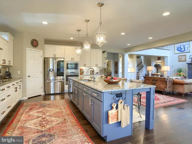 a dining room with furniture a fireplace and large windows