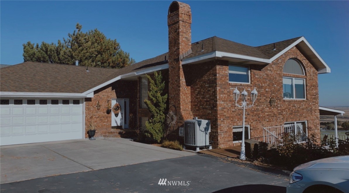 a front view of a house with parking space