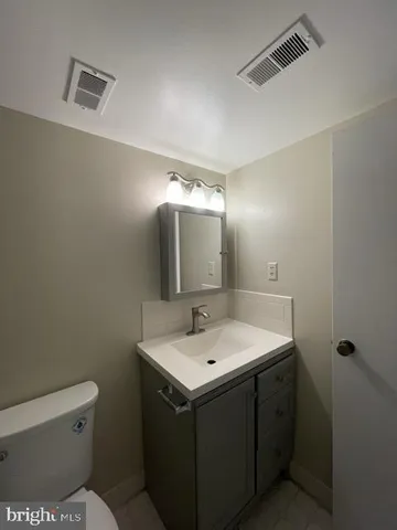 a view of an empty room and chandelier