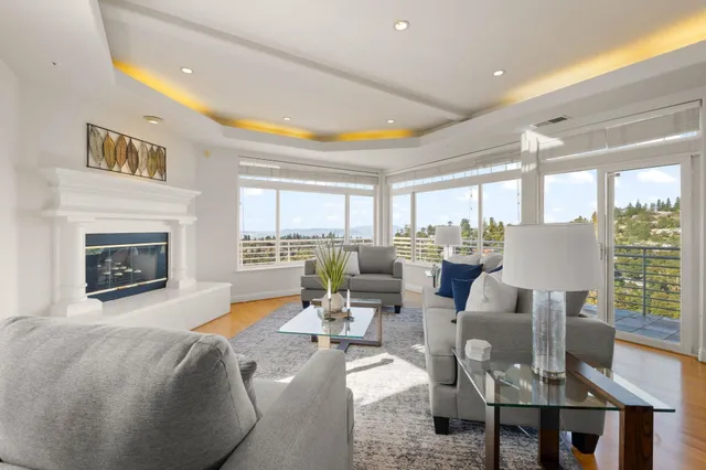 a bedroom with a large bed couch and a large window