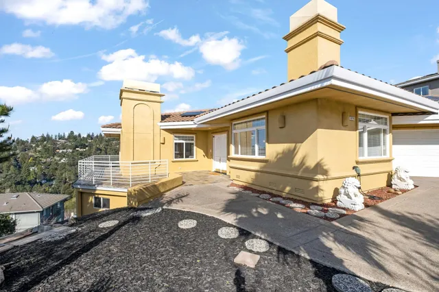 a living room with furniture a chandelier and a fireplace