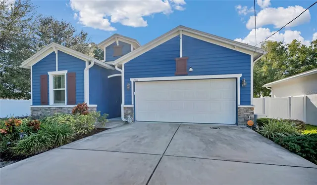 a front view of house with yard and trees around