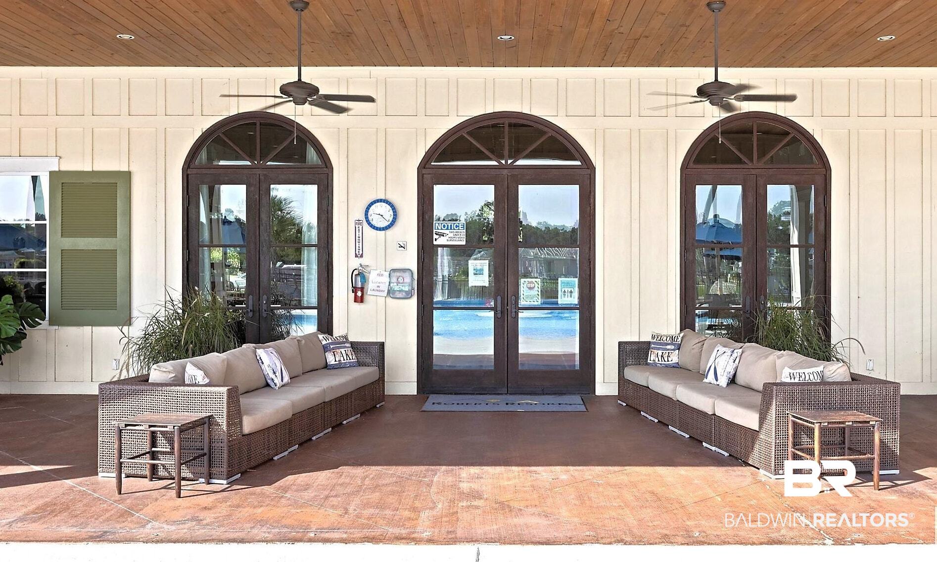 28086 Migratory Way Elberta, AL 36530 - Photo 24 of 46 Property entrance featuring french doors, an outdoor hangout area, and ceiling fan