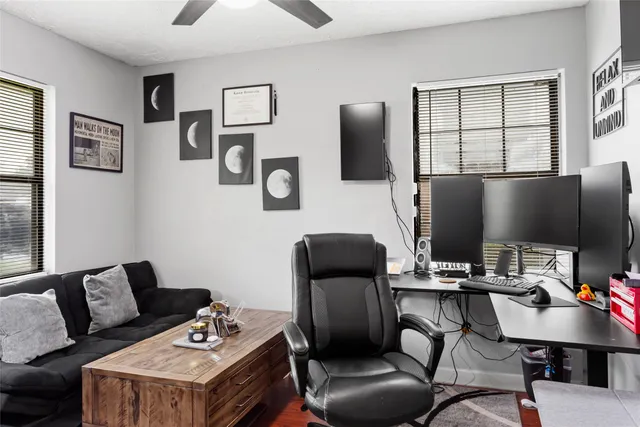 a work room with furniture and a flat screen tv