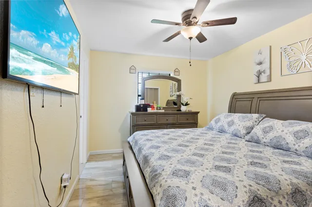 a bedroom with a large bed and a chandelier