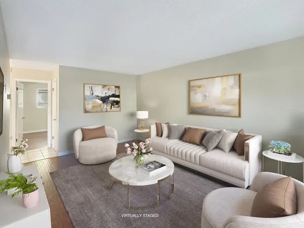a living room with furniture and wooden floor