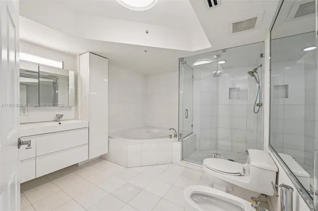 a bathroom with a bathtub and shower