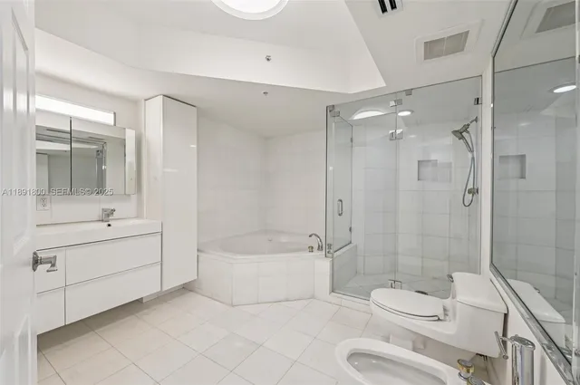 a bathroom with a bathtub and shower