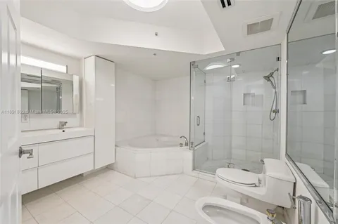 a bathroom with a bathtub and shower