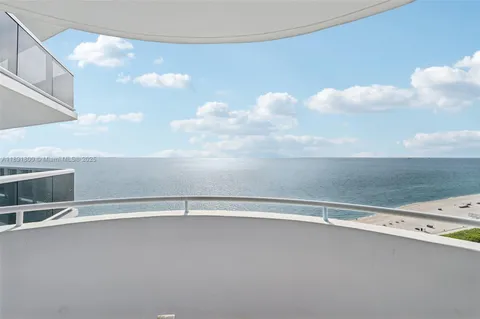 a kitchen with stainless steel appliances granite countertop a sink and white cabinets