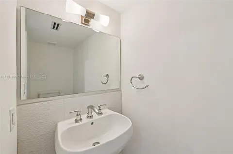 a bathroom with a shower a sink and a mirror