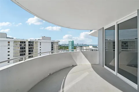a front view of a building with palm trees