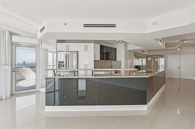 a kitchen with stainless steel appliances a refrigerator and a cabinets