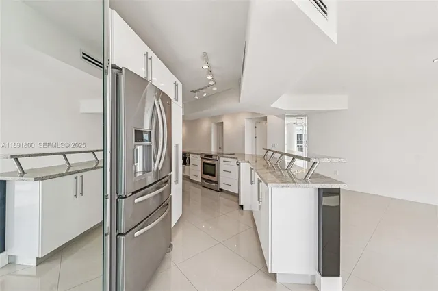 a view of a kitchen with electric appliances