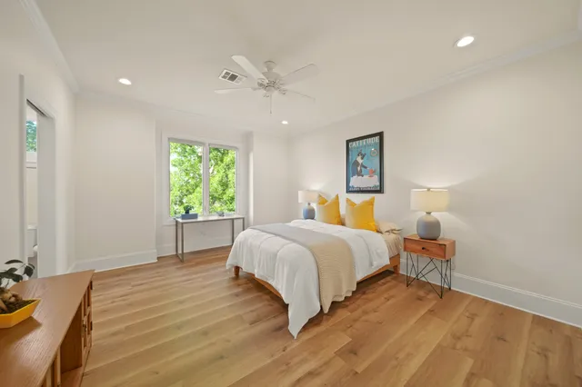 a front view of a house with a yard and potted plants