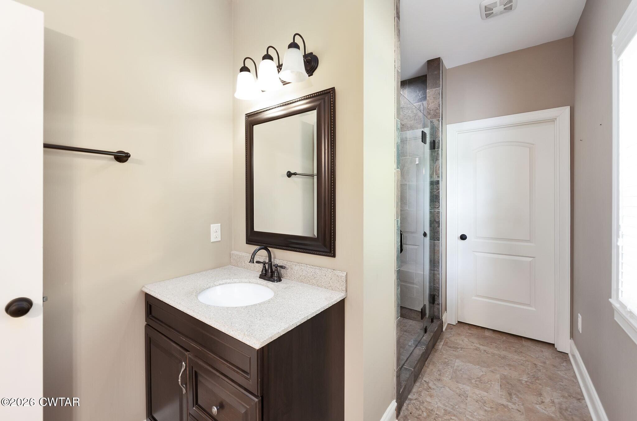 4080 Beech Bluff Road Beech Bluff, TN 38313 - Photo 30 of 41 a bathroom with a sink toilet and mirror