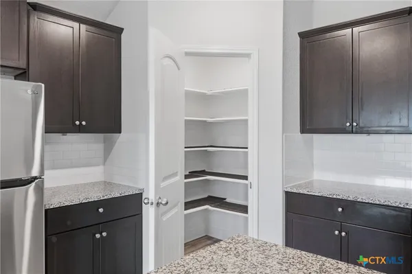 a kitchen with a refrigerator and cabinets