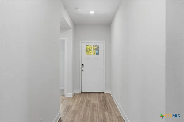 a view of room with wooden floor and window