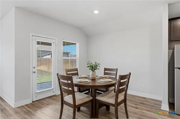 a view of a dining room with furniture and wooden floor
