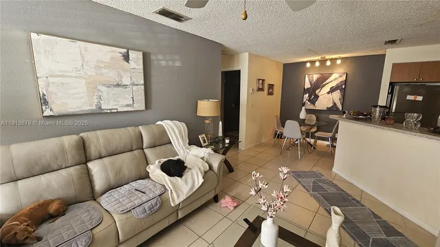 a living room with furniture a flat screen tv and a large window