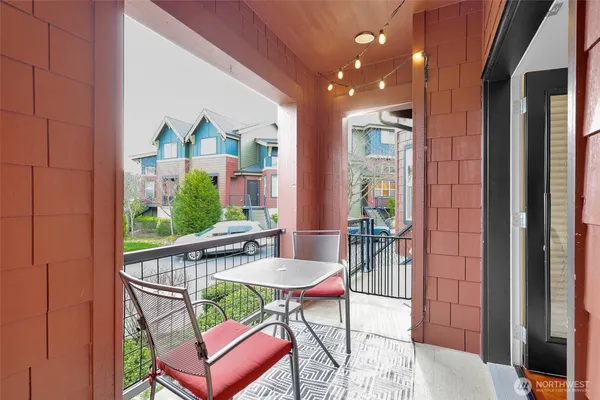a view of a balcony dining table and chairs