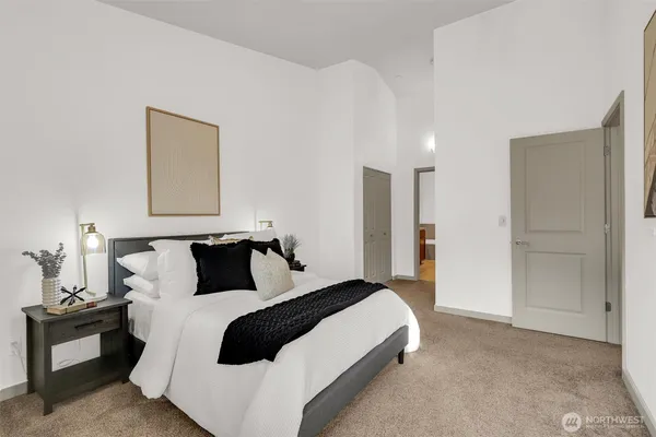 a bedroom with a bed and a lamp