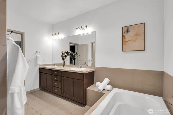 a bathroom with a sink vanity and mirror