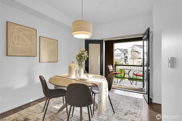 a dining room with furniture and a floor to ceiling window