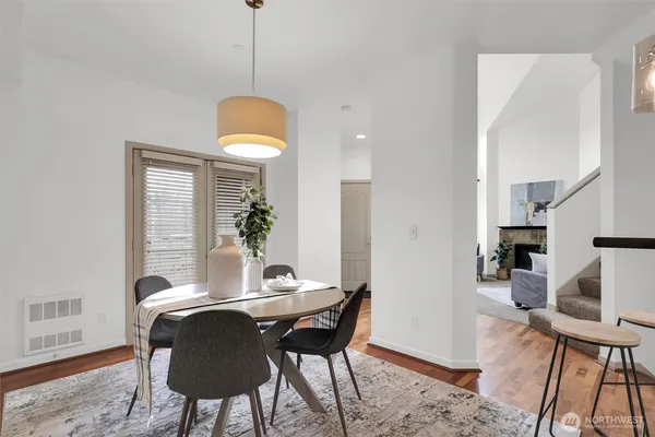 a dining room with furniture and wooden floor