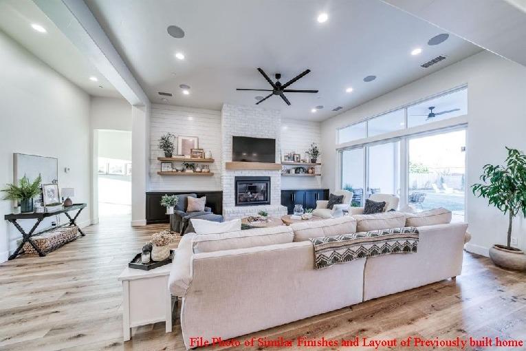 14480 Academy Oaks Lane Clovis, CA 93619 - Photo 19 of 37 a living room with furniture a fireplace and a flat screen tv