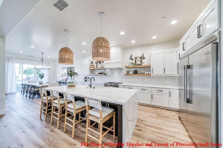 14480 Academy Oaks Lane Clovis, CA 93619 - Photo 23 of 37 a large kitchen with kitchen island a dining table and chairs