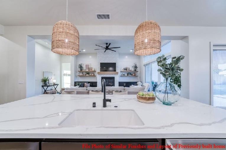 14480 Academy Oaks Lane Clovis, CA 93619 - Photo 25 of 37 a kitchen with a sink and a chandelier