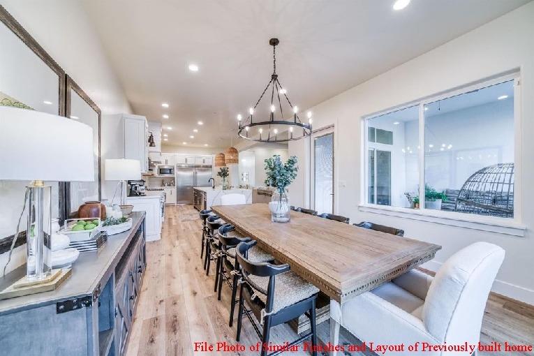 14480 Academy Oaks Lane Clovis, CA 93619 - Photo 29 of 37 a view of a dining room and livingroom with furniture wooden floor a rug a painting and a chandelier