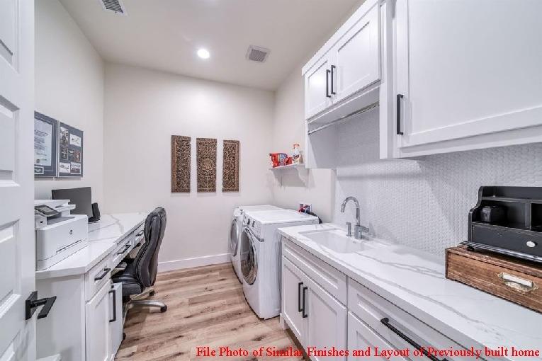 14480 Academy Oaks Lane Clovis, CA 93619 - Photo 30 of 37 a kitchen that has a lot of cabinets in it and wooden floors