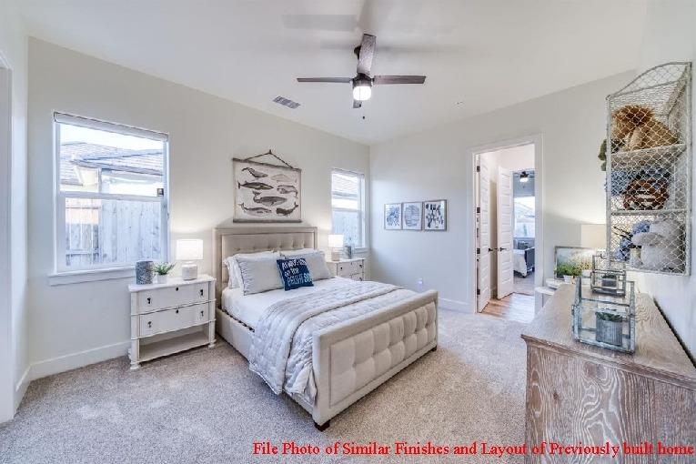 14480 Academy Oaks Lane Clovis, CA 93619 - Photo 32 of 37 a bedroom with a bed and a chandelier