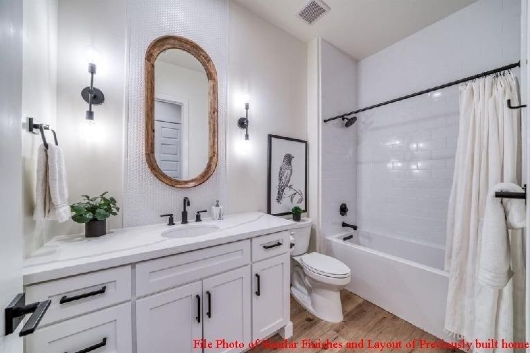 14480 Academy Oaks Lane Clovis, CA 93619 - Photo 33 of 37 a bathroom with a double vanity sink toilet mirror and shower