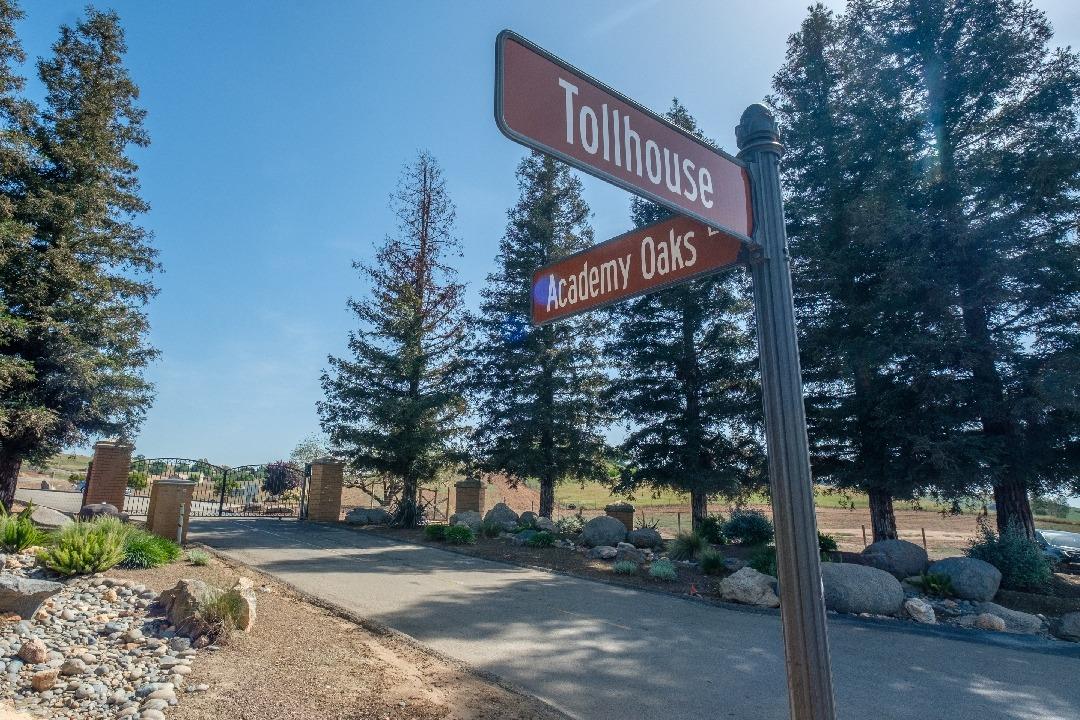 14480 Academy Oaks Lane Clovis, CA 93619 - Photo 8 of 37 a street sign on a sidewalk next to a road