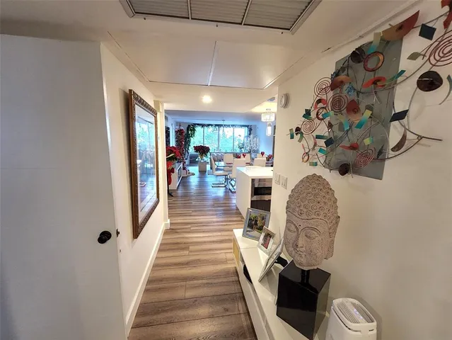 a view of entryway and hall with wooden floor